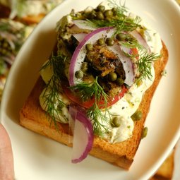 Toast with Tinned Fish, Everything Cream Cheese, Tomatoes, Capers, Purple Onions & Lettuce
